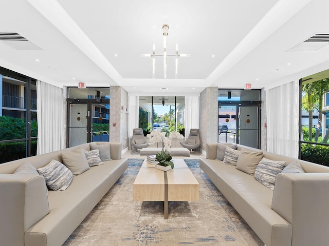 living area with floor to ceiling windows, visible vents, a chandelier, and recessed lighting