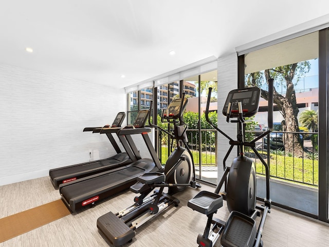 workout area featuring baseboards and recessed lighting