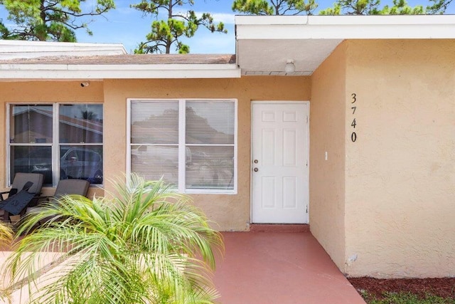 property entrance with stucco siding