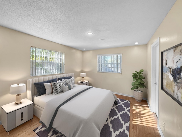 6875 NW 1st Ct, Margate, FL 33063 - bedroom featuring recessed lighting, light wood finished floors, multiple windows, and a textured ceiling