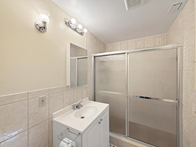 6875 NW 1st Ct, Margate, FL 33063 - bathroom featuring vanity, tile walls, visible vents, and a stall shower