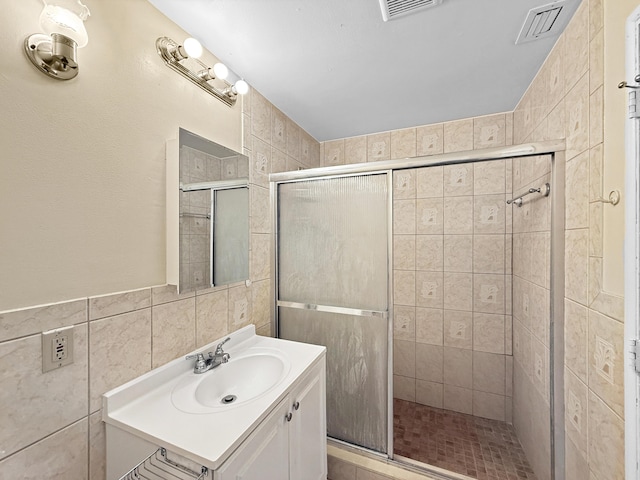 6875 NW 1st Ct, Margate, FL 33063 - full bath with a stall shower, vanity, visible vents, and tile walls