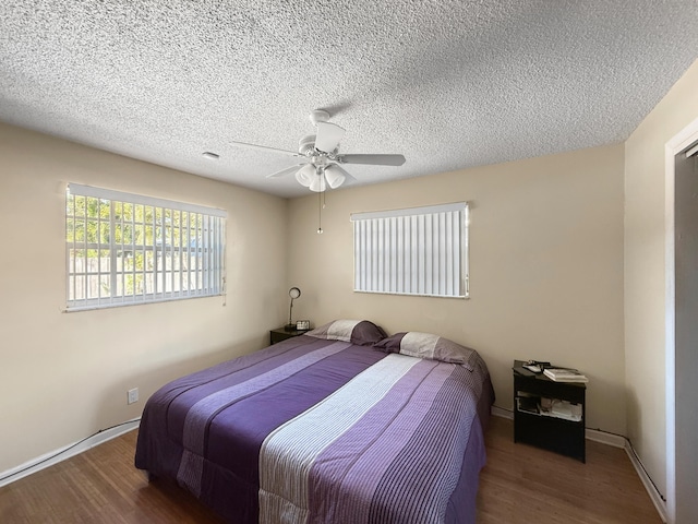 6875 NW 1st Ct, Margate, FL 33063 - bedroom featuring a textured ceiling, a ceiling fan, and wood finished floors