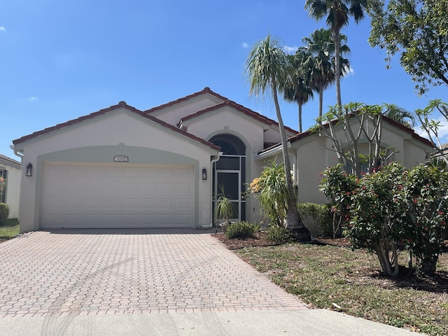 7007 Ashton St, Boynton Beach, FL 33437 - ranch-style home featuring a garage, stucco siding, a tile roof, and decorative driveway