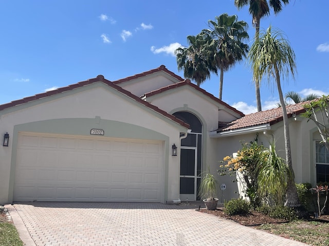 7007 Ashton St, Boynton Beach, FL 33437 - view of front of home featuring a garage, stucco siding, and decorative driveway