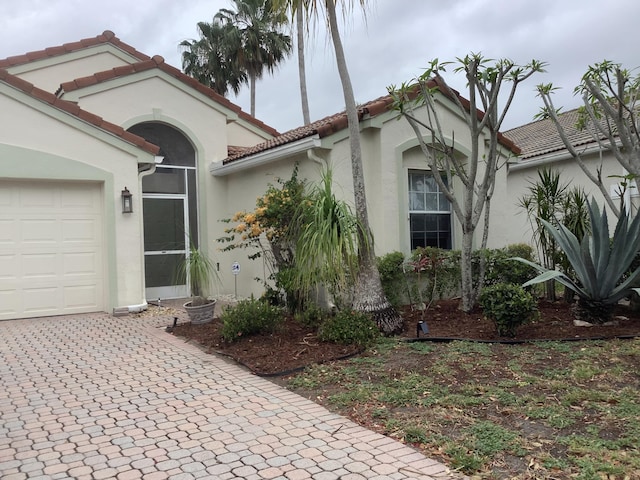 7007 Ashton St, Boynton Beach, FL 33437 - mediterranean / spanish house with driveway, a tile roof, a garage, and stucco siding