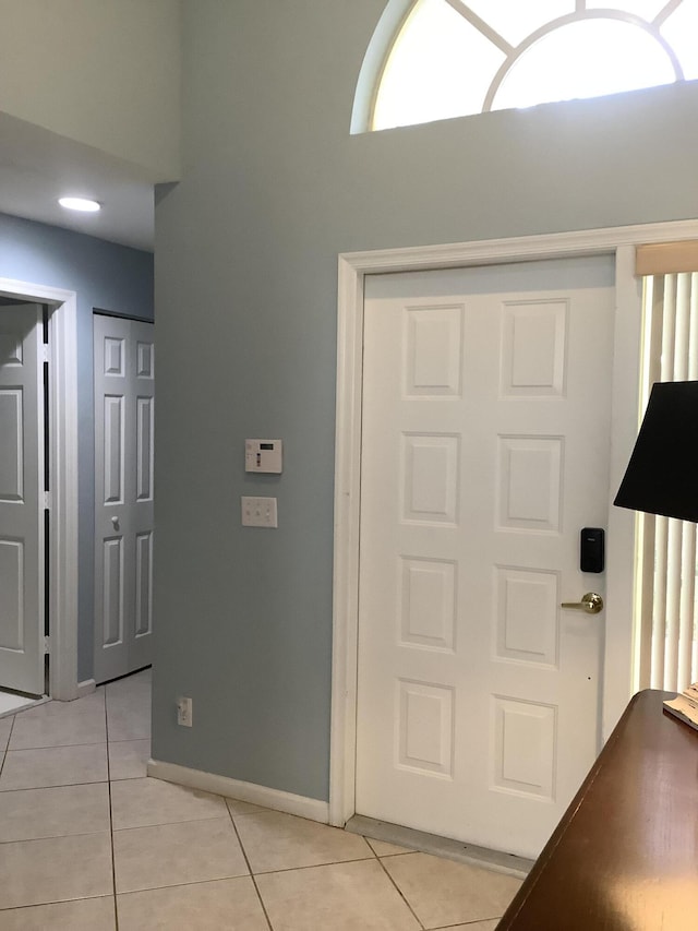 7007 Ashton St, Boynton Beach, FL 33437 - foyer with light tile patterned floors, a towering ceiling, and baseboards