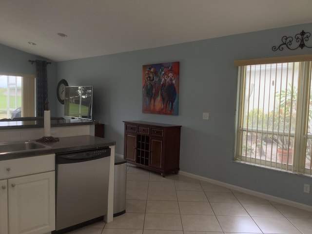7007 Ashton St, Boynton Beach, FL 33437 - kitchen with white cabinets, dark countertops, stainless steel dishwasher, light tile patterned flooring, and lofted ceiling
