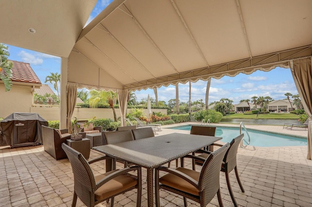 13315 Deauville Dr, Palm Beach Gardens, FL 33410 - view of patio with an outdoor pool, fence, and outdoor dining space