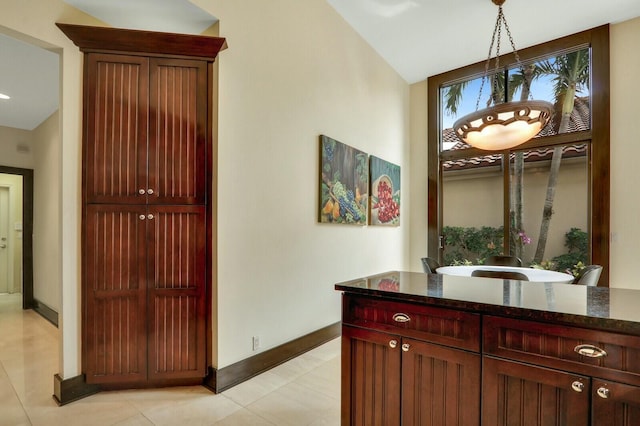 13315 Deauville Dr, Palm Beach Gardens, FL 33410 - corridor with plenty of natural light, baseboards, light tile patterned flooring, and vaulted ceiling