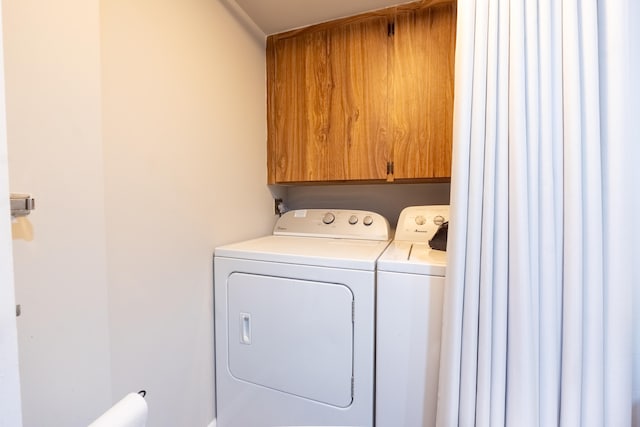 laundry room with cabinet space and washing machine and clothes dryer