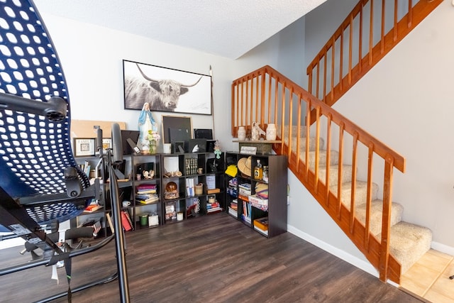 stairway with baseboards and wood finished floors