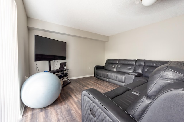 living room featuring baseboards and wood finished floors