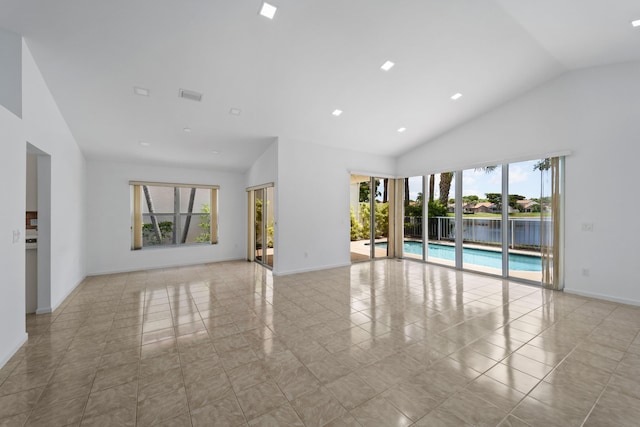 22586 Esplanada Dr, Boca Raton, FL 33433 - spare room with high vaulted ceiling, baseboards, and visible vents