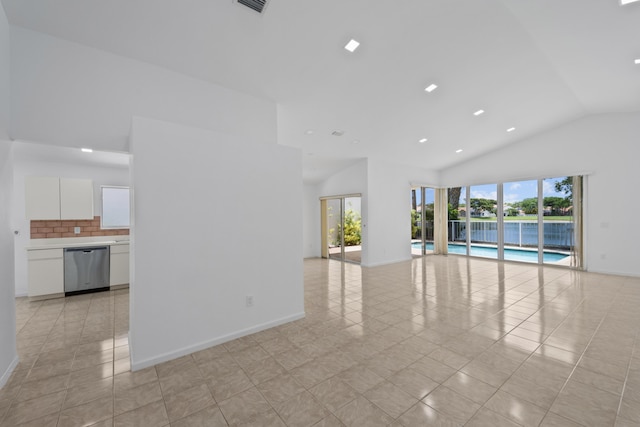 22586 Esplanada Dr, Boca Raton, FL 33433 - spare room with light tile patterned floors, high vaulted ceiling, and baseboards