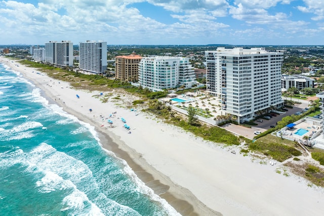 aerial view with a view of the beach, a water view, and a view of city