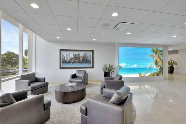 living room with visible vents, a drop ceiling, and recessed lighting