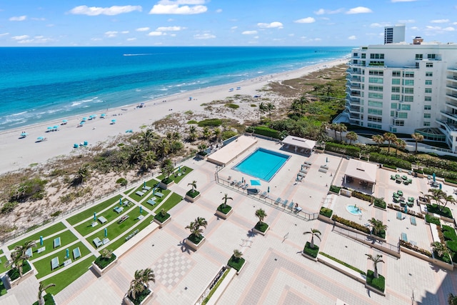 drone / aerial view featuring a view of the beach and a water view