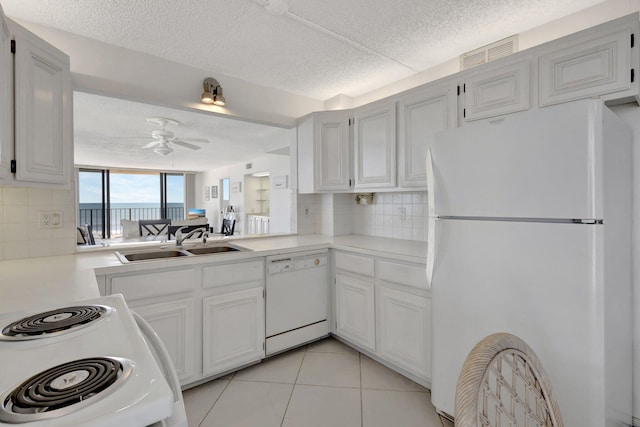 10000 S Ocean Dr S Unit 601, Jensen Beach, FL 34957 - kitchen with white appliances, visible vents, light countertops, and a sink