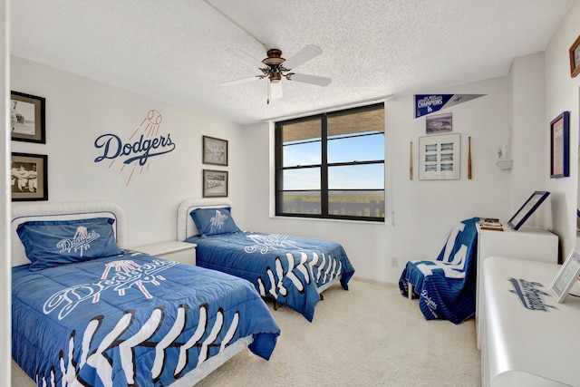 10000 S Ocean Dr S Unit 601, Jensen Beach, FL 34957 - carpeted bedroom with baseboards, a textured ceiling, and ceiling fan