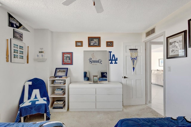 10000 S Ocean Dr S Unit 601, Jensen Beach, FL 34957 - bedroom featuring a textured ceiling, visible vents, a ceiling fan, and light carpet