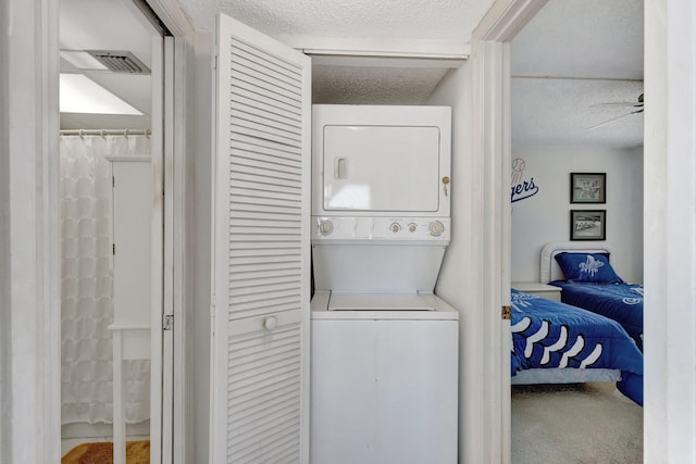 10000 S Ocean Dr S Unit 601, Jensen Beach, FL 34957 - washroom with stacked washer and clothes dryer, laundry area, and a textured ceiling