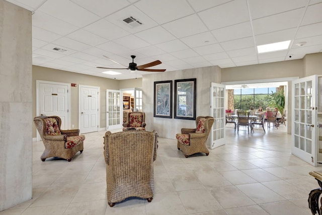 10000 S Ocean Dr S Unit 601, Jensen Beach, FL 34957 - living room featuring ceiling fan, visible vents, french doors, and a paneled ceiling