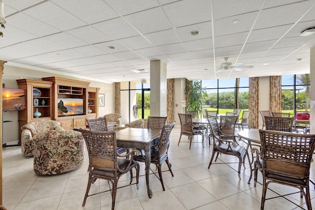 10000 S Ocean Dr S Unit 601, Jensen Beach, FL 34957 - dining space featuring a drop ceiling, light tile patterned floors, a ceiling fan, and a wealth of natural light
