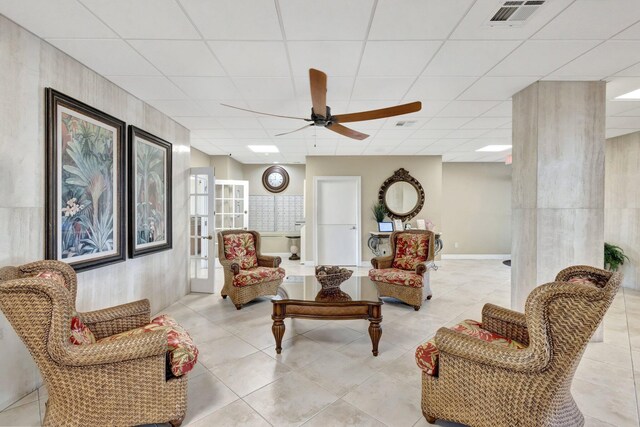 10000 S Ocean Dr S Unit 601, Jensen Beach, FL 34957 - living area with light tile patterned flooring, ceiling fan, visible vents, and a paneled ceiling