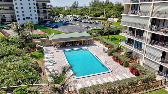 10000 S Ocean Dr S Unit 601, Jensen Beach, FL 34957 - community pool with fence and a patio area