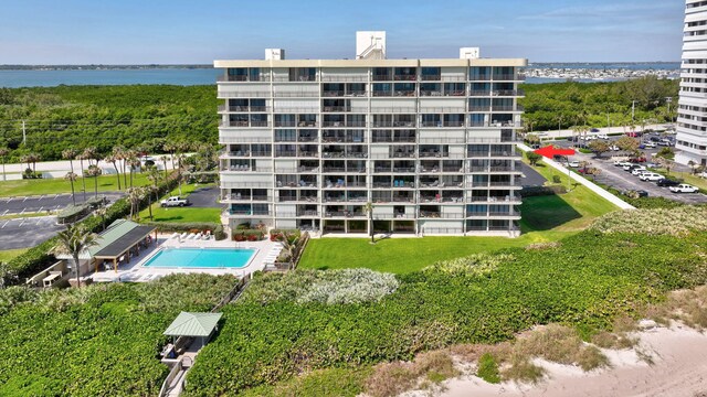 10000 S Ocean Dr S Unit 601, Jensen Beach, FL 34957 - view of building exterior featuring a community pool and a water view