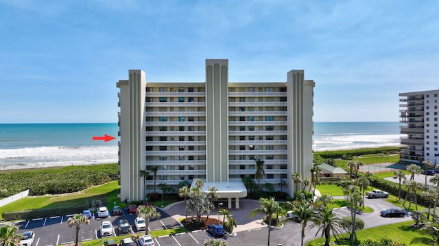 10000 S Ocean Dr S Unit 601, Jensen Beach, FL 34957 - view of property featuring a beach view, uncovered parking, and a water view