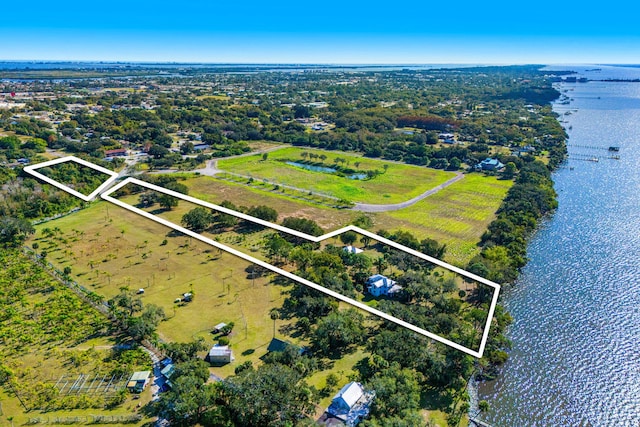 drone / aerial view featuring a water view and a rural view