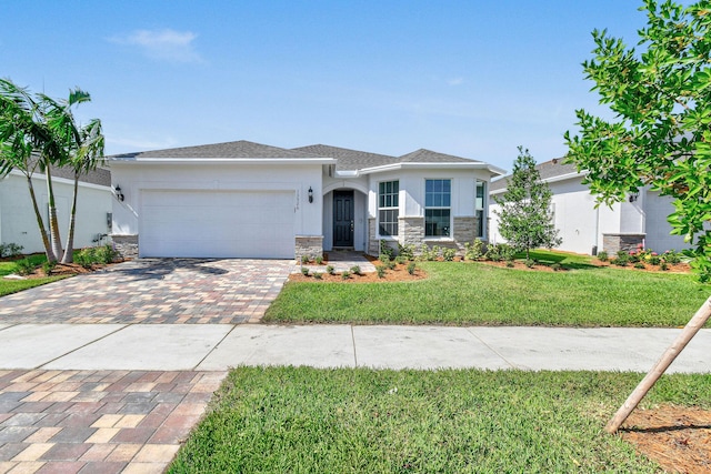 13526 Sw Vermillion Circle Mystique, Port Saint Lucie, FL 34987 - view of front of property featuring decorative driveway, stone siding, stucco siding, a garage, and a front lawn