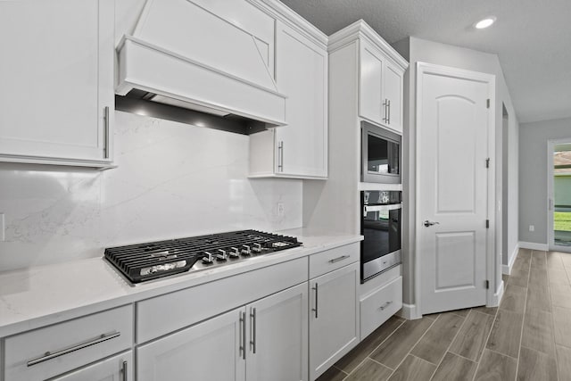 13526 Sw Vermillion Circle Mystique, Port Saint Lucie, FL 34987 - kitchen featuring stainless steel appliances, custom range hood, white cabinetry, backsplash, and recessed lighting