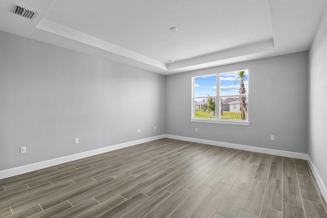 13526 Sw Vermillion Circle Mystique, Port Saint Lucie, FL 34987 - unfurnished room with a raised ceiling and wood finished floors