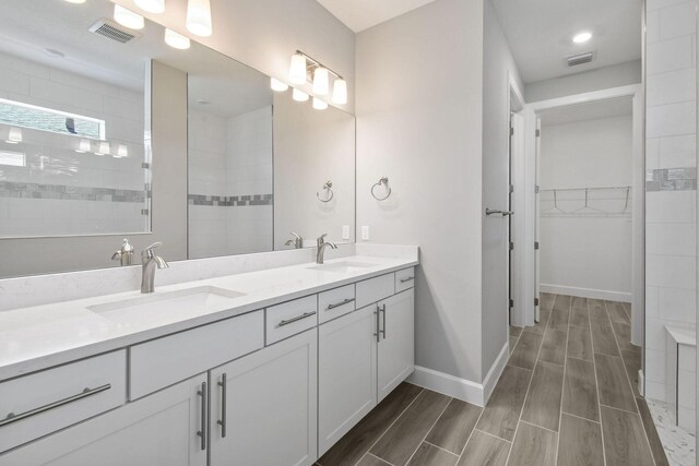 13526 Sw Vermillion Circle Mystique, Port Saint Lucie, FL 34987 - full bathroom with double vanity, wood finish floors, a spacious closet, and tiled shower