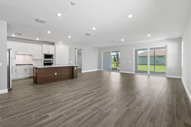 13526 Sw Vermillion Circle Mystique, Port Saint Lucie, FL 34987 - unfurnished living room with wood finished floors and recessed lighting