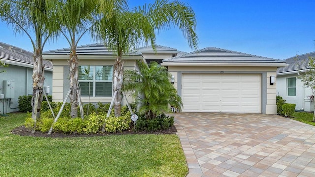 11994 SW Bristol Bay Dr, Port Saint Lucie, FL 34987 - view of front of property featuring a tile roof, stucco siding, and an attached garage