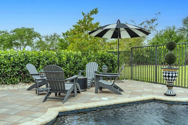 11994 SW Bristol Bay Dr, Port Saint Lucie, FL 34987 - view of swimming pool with a yard, fence, and a patio