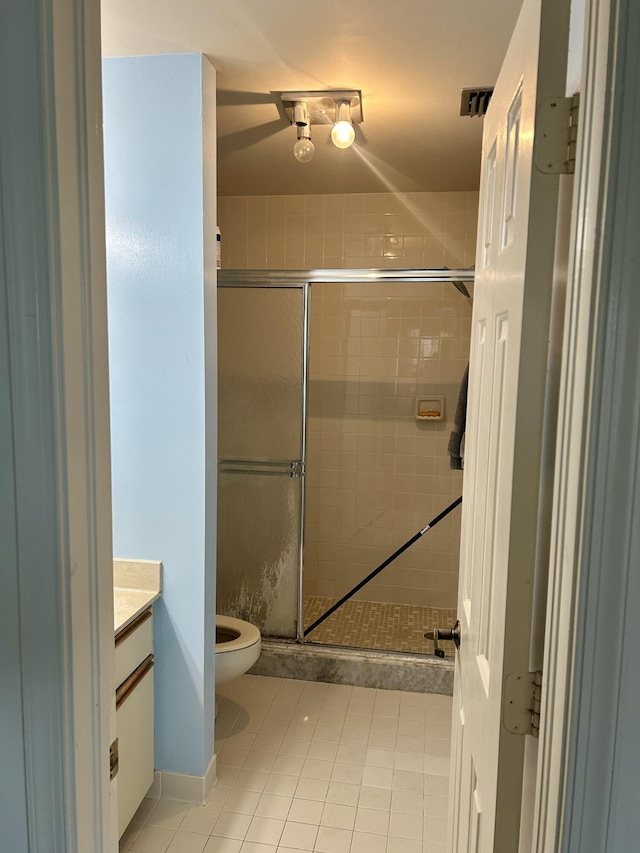 6001 SE Landing Way Unit 10, Stuart, FL 34997 - bathroom featuring vanity, a shower stall, tile patterned floors, and toilet