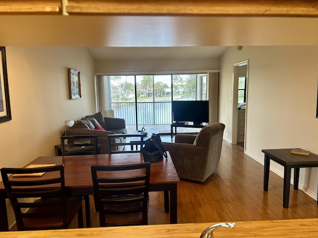 6001 SE Landing Way Unit 10, Stuart, FL 34997 - living area featuring wood finished floors, lofted ceiling, and baseboards