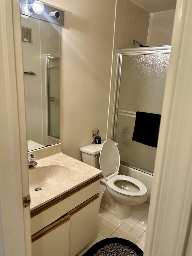 6001 SE Landing Way Unit 10, Stuart, FL 34997 - bathroom featuring tile patterned flooring, toilet, vanity, and bath / shower combo with glass door