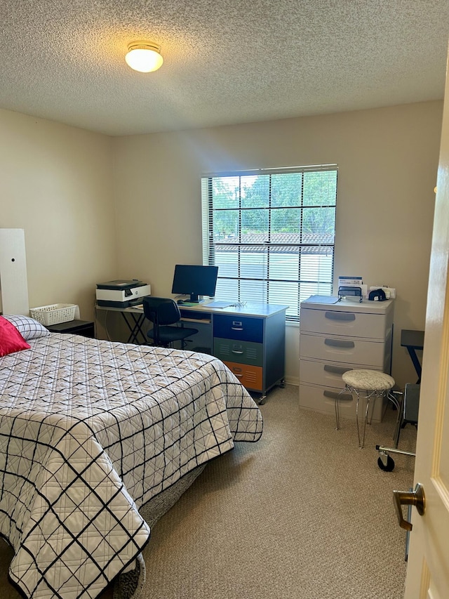 6001 SE Landing Way Unit 10, Stuart, FL 34997 - carpeted bedroom featuring a textured ceiling and a desk