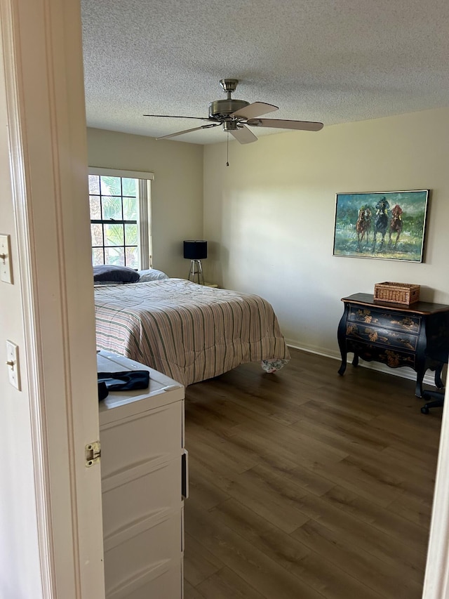 6001 SE Landing Way Unit 10, Stuart, FL 34997 - bedroom with a textured ceiling, wood finished floors, baseboards, and ceiling fan