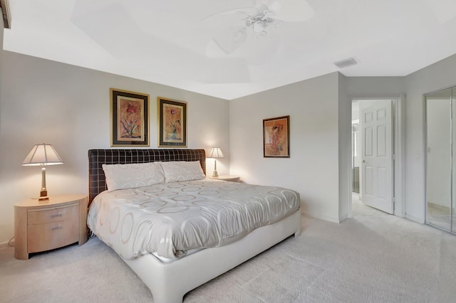 bedroom featuring baseboards, ceiling fan, visible vents, and light carpet