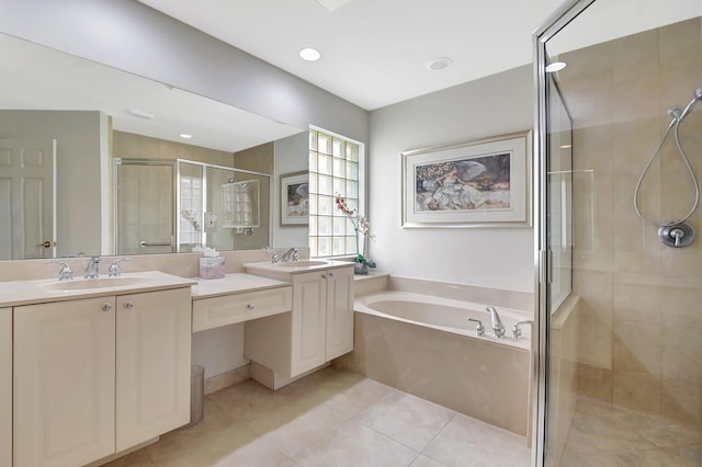 full bathroom with a bath, a shower stall, double vanity, a sink, and tile patterned flooring