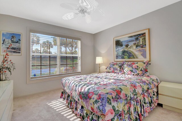 carpeted bedroom featuring ceiling fan