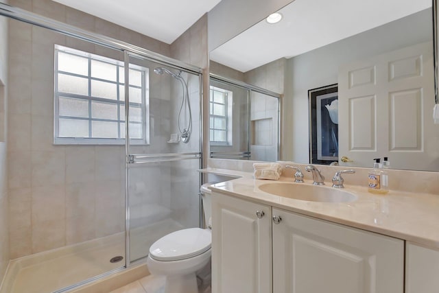 bathroom with a stall shower, tile patterned floors, toilet, and vanity