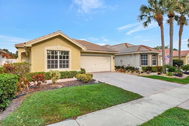 ranch-style house with driveway, stucco siding, an attached garage, and a tiled roof